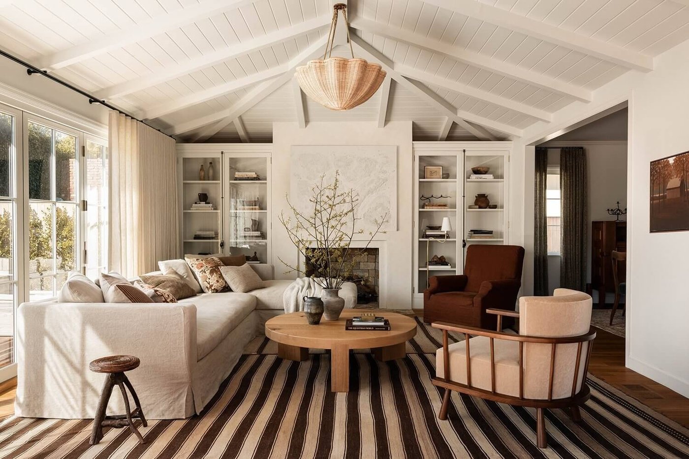 Warm, sunlit living room with cream seating and a vaulted ceiling